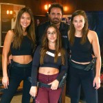 Taran tactical thats the owner of the shooting range in the back and even he has to be careful were he places his hands as an embrace clearly at waist level and side.....no fondling/raping/groping/sexual assaults or 'illegal touching' as these gals are armed and if you tune into their videos very well trained in firearms....LOL